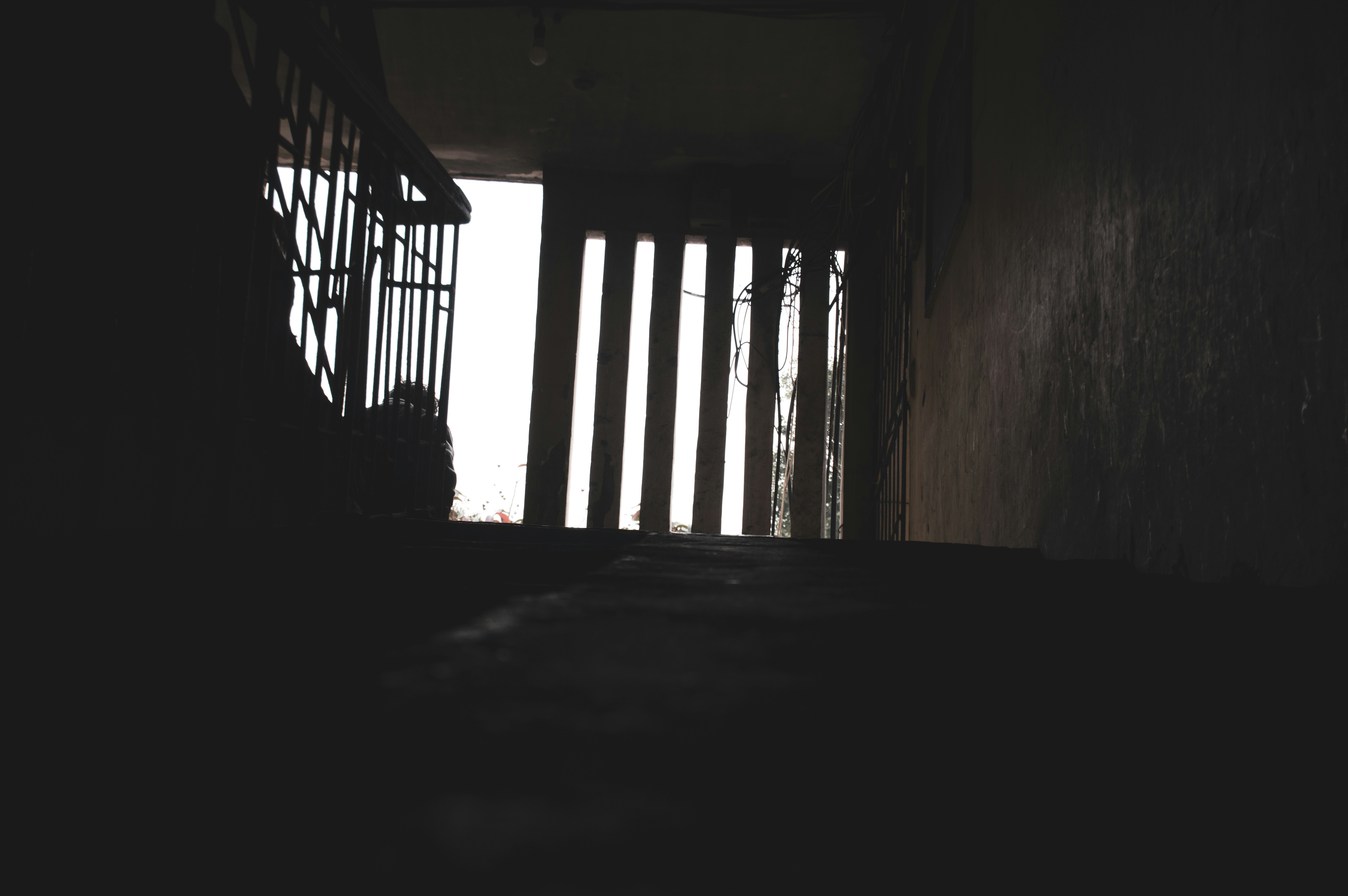 a dark hallway with a light coming through the window