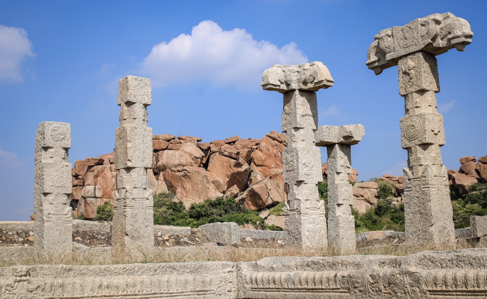 a group of stone pillars sitting next to each other