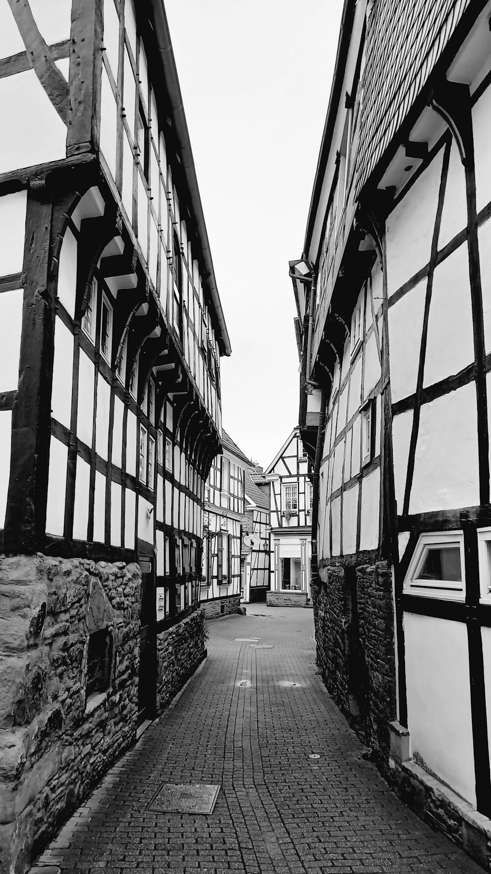 a black and white photo of a cobblestone street