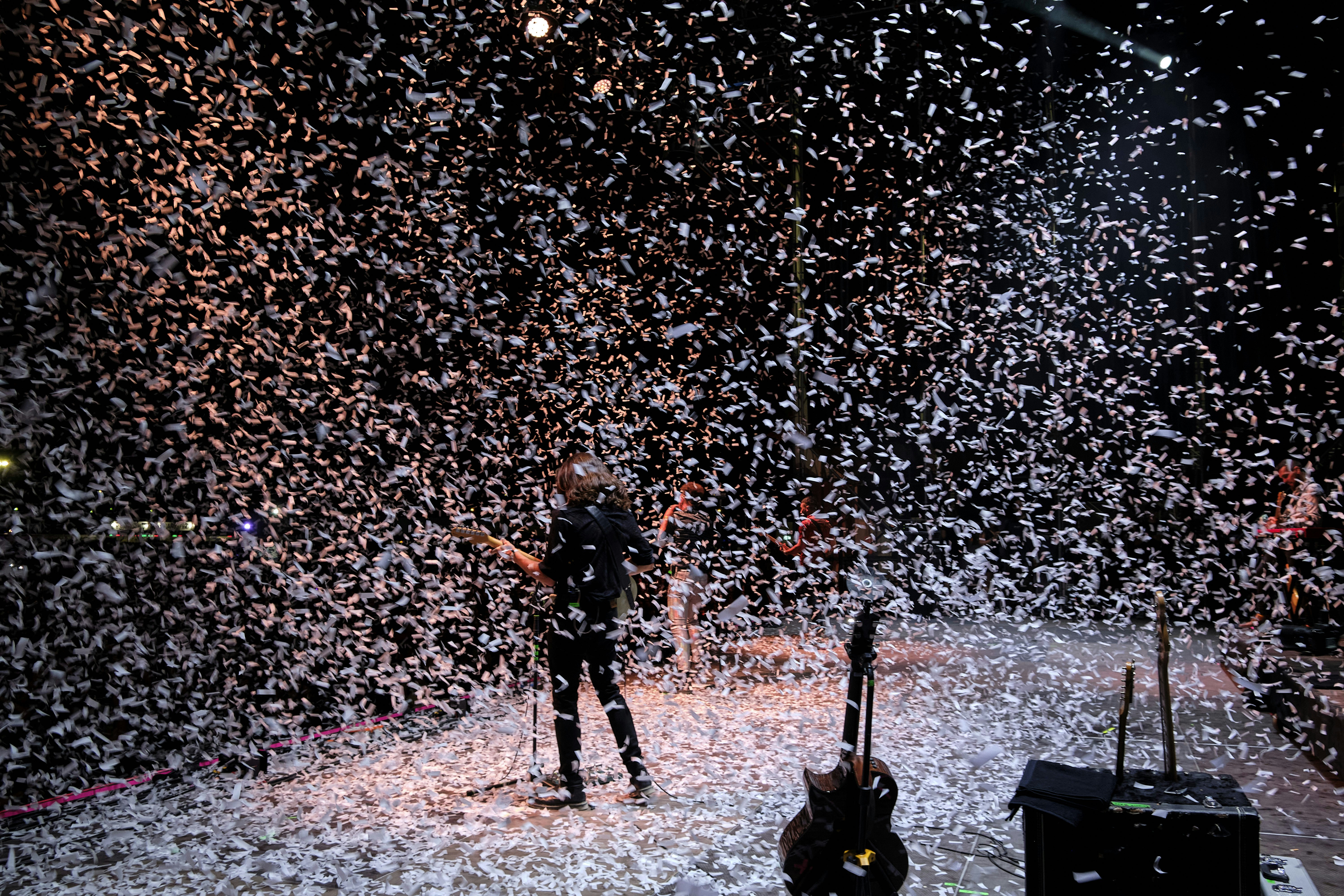 a man standing on a stage surrounded by confetti