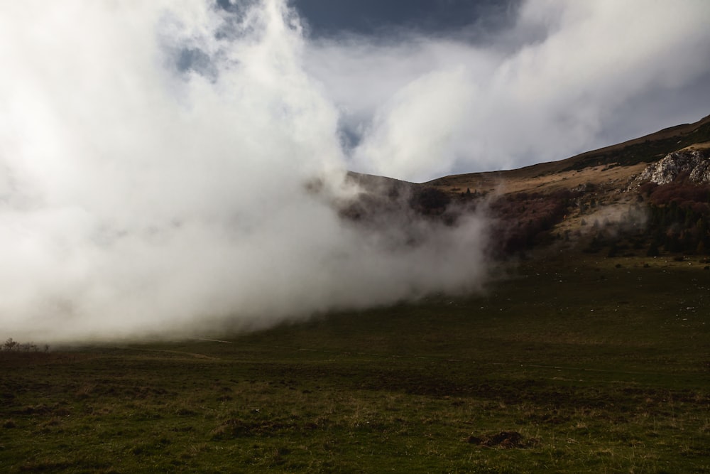 a large cloud of steam rising from the ground
