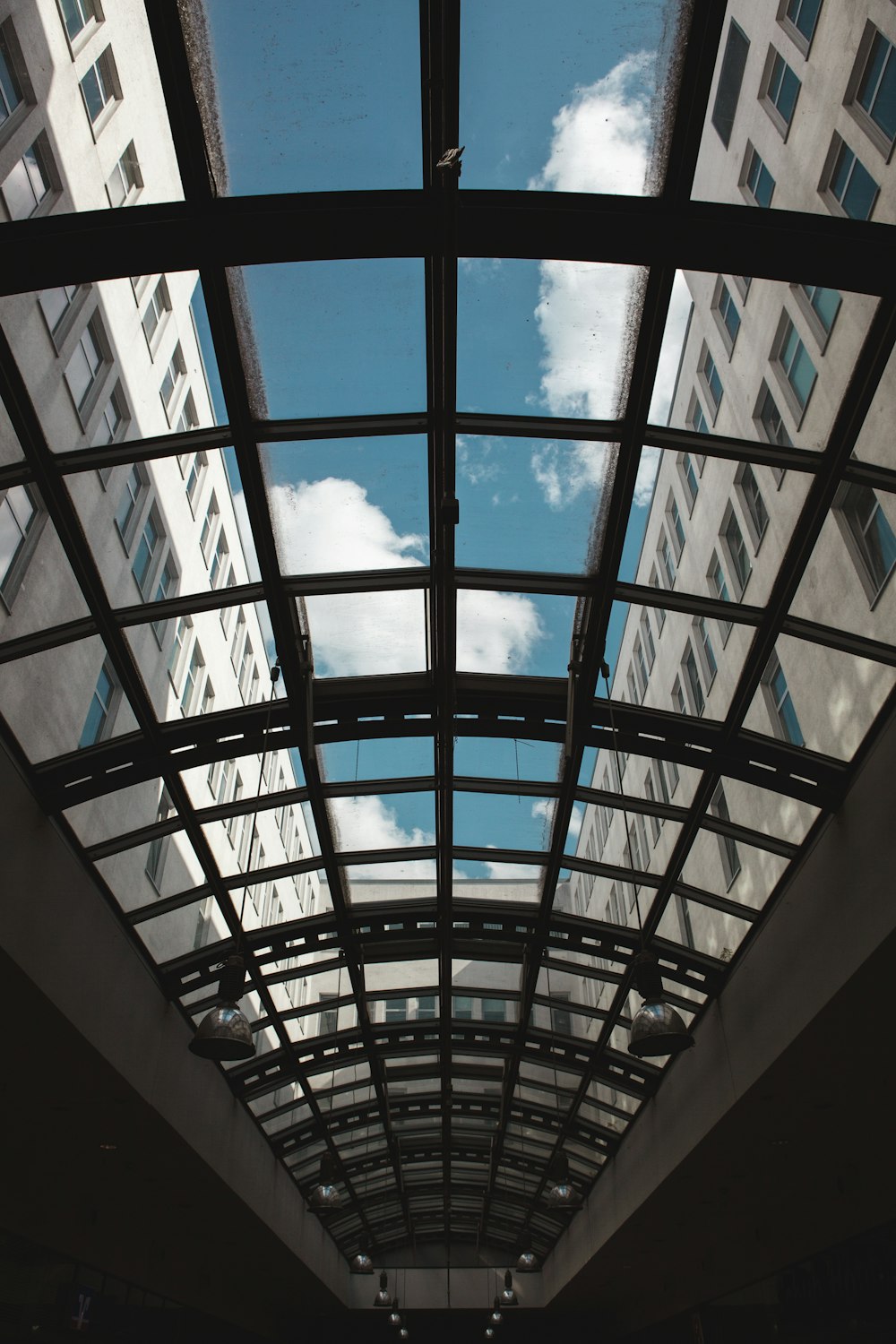 a view of the sky through a glass roof