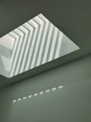 Abstract patterns formed by light and shadow on a modern surface.