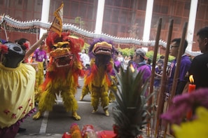 Traditional Zambian dancers performing alongside Chinese lion dancers at a cultural exchange event