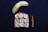 A halved banana sits alongside a slice of toast topped with peanut butter, banana slices, and sprinkled with black seeds. Nearby, a few whole peanuts add a complementary touch to this dark background setup.