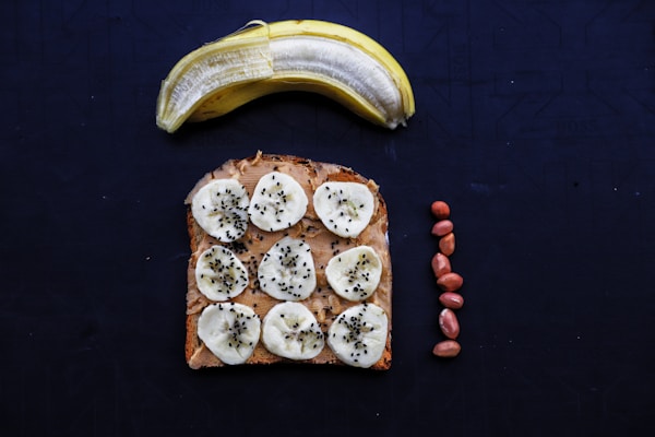 A peanut butter and banana sandwich on a blue surface