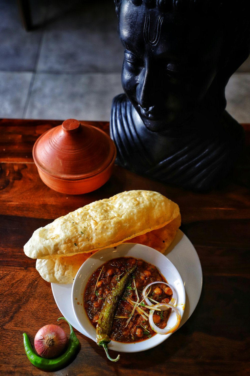 a bowl of soup and a piece of bread on a table