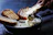 Close-up of a bubbling cheese fondue served with fresh bread cubes.