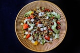 Chef carefully garnishing a colorful, vibrant salad.
