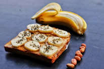 a piece of bread with bananas and nuts on it