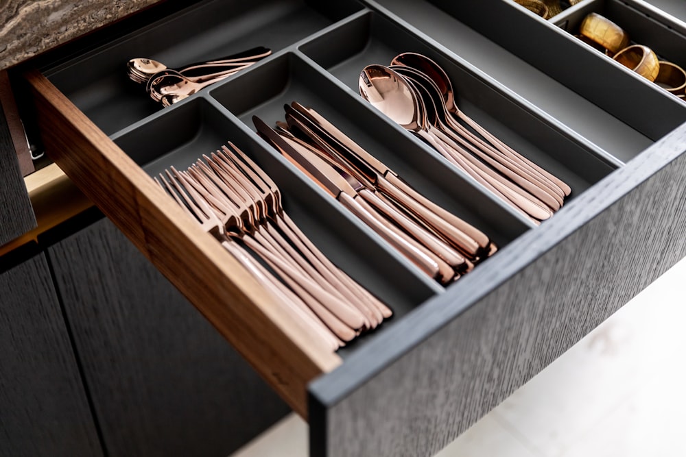 a drawer with utensils and spoons in it