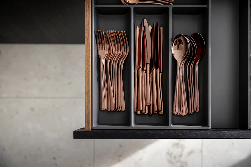 Organized wooden kitchen drawer with cutlery