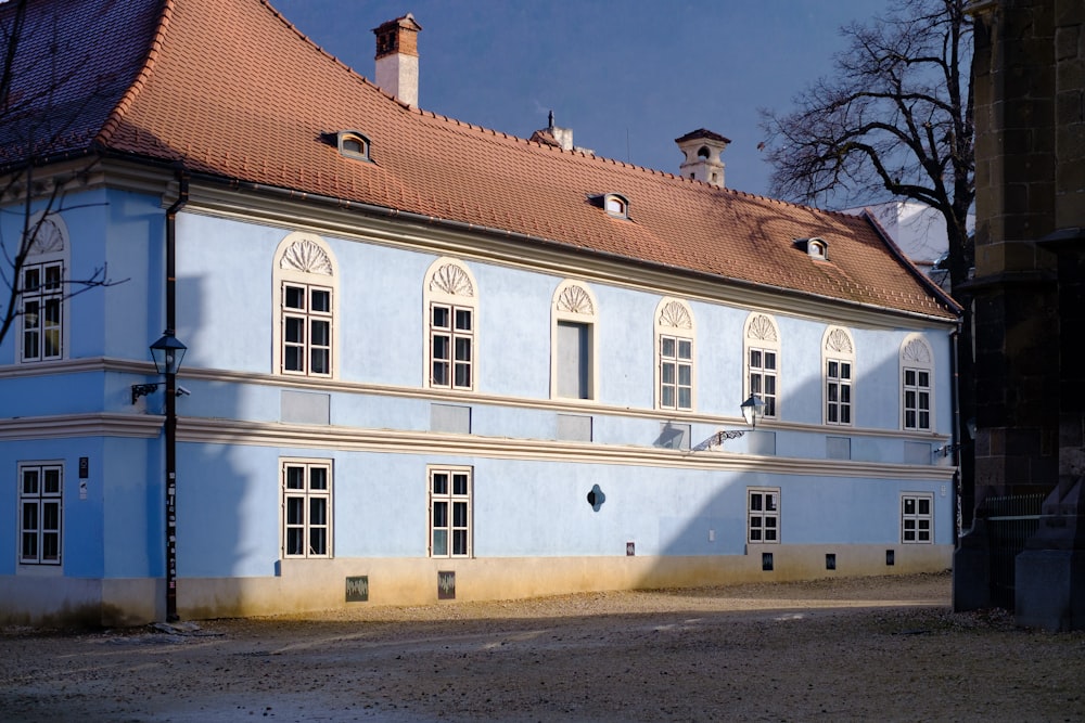 a large blue building with a red roof