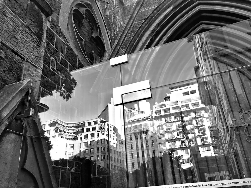 a reflection of buildings in a glass window