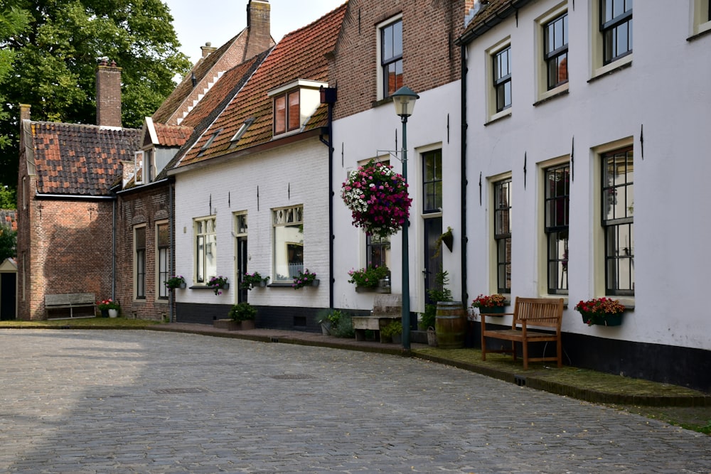 a cobblestone street lined with white buildings