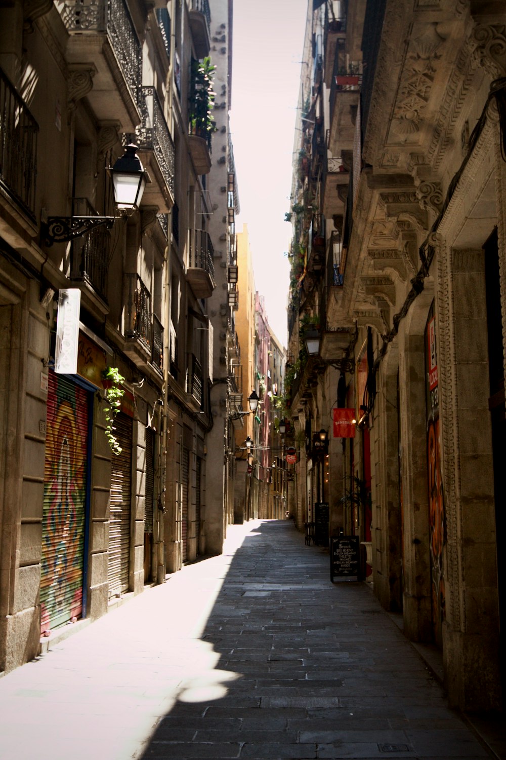 a narrow city street lined with tall buildings