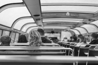 A group of travelers comfortably seated inside a spacious vehicle.