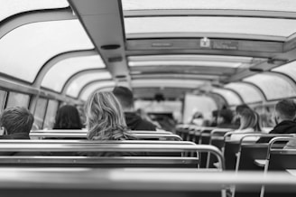 Business professionals and a family comfortably seated inside a spacious vehicle driving through a cityscape.