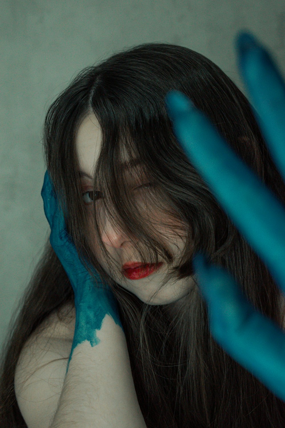 a woman with blue paint on her hands