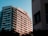 A modern residential building complex under clear skies representing urban real estate development.
