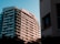 A modern residential building complex under clear skies representing urban real estate development.