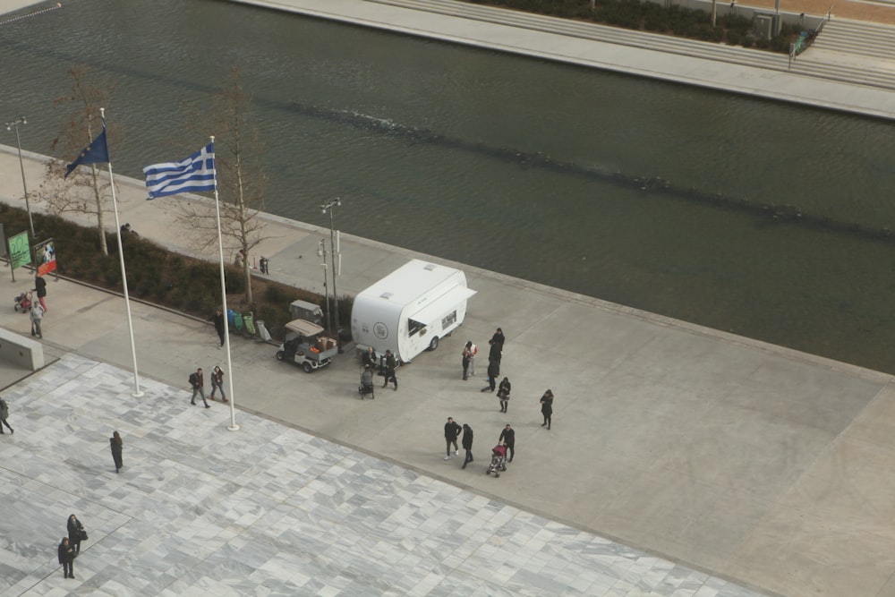 a group of people standing around a white truck