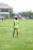 Photo of a happy customer wearing a futbolis jersey on a sunny soccer field.