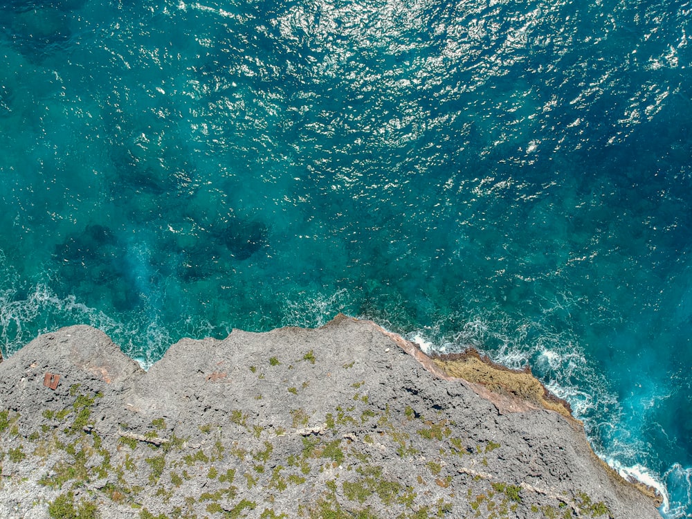 a bird's eye view of the ocean and rocks