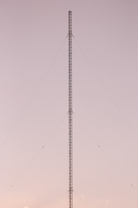 a very tall tower sitting in the middle of a field