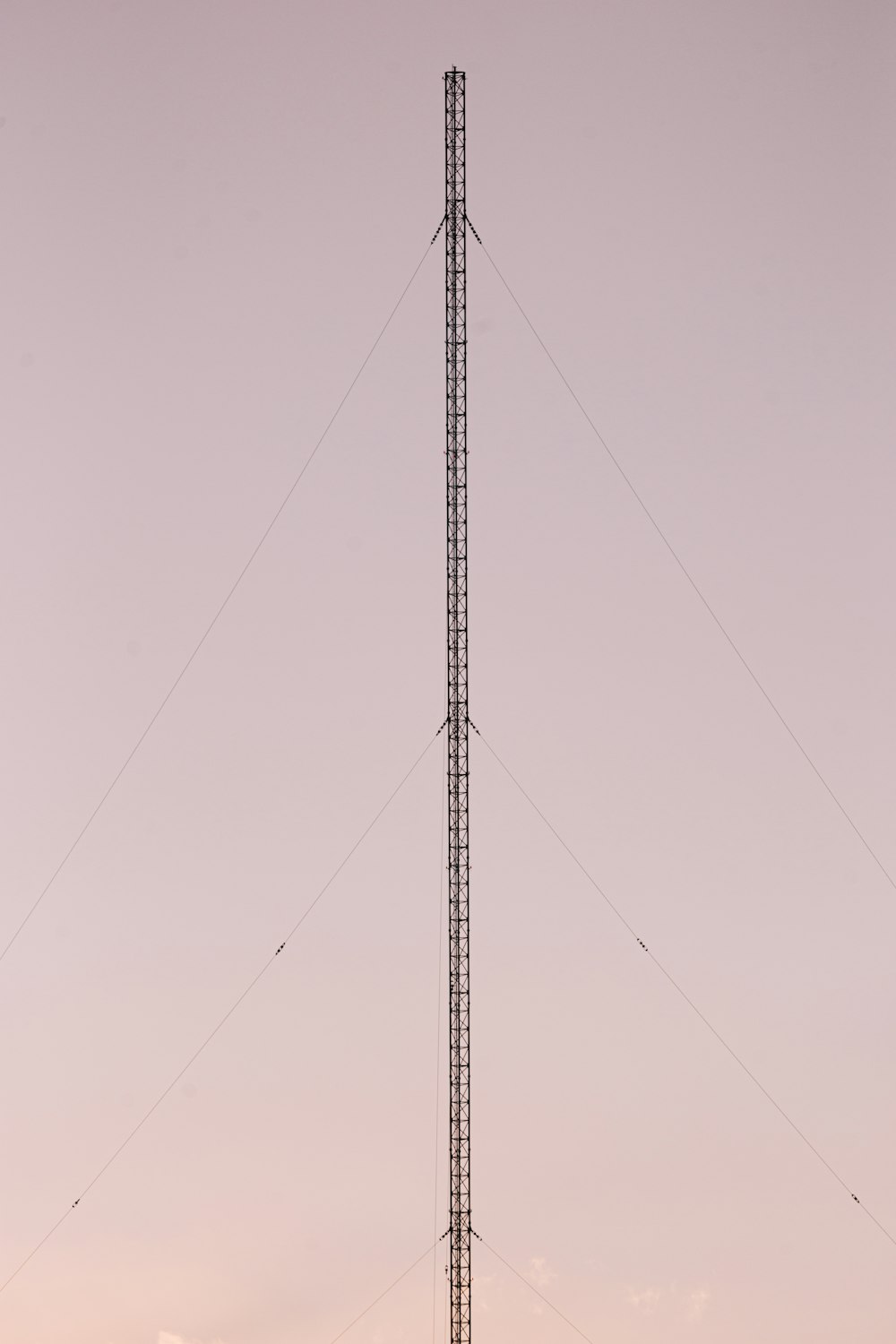 a very tall tower sitting in the middle of a field