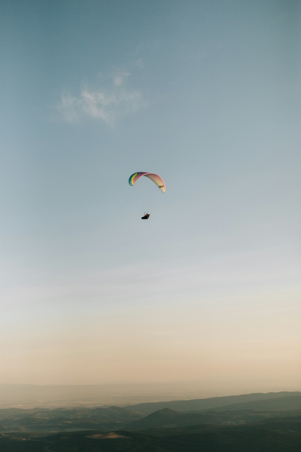 a paraglider is flying high in the sky