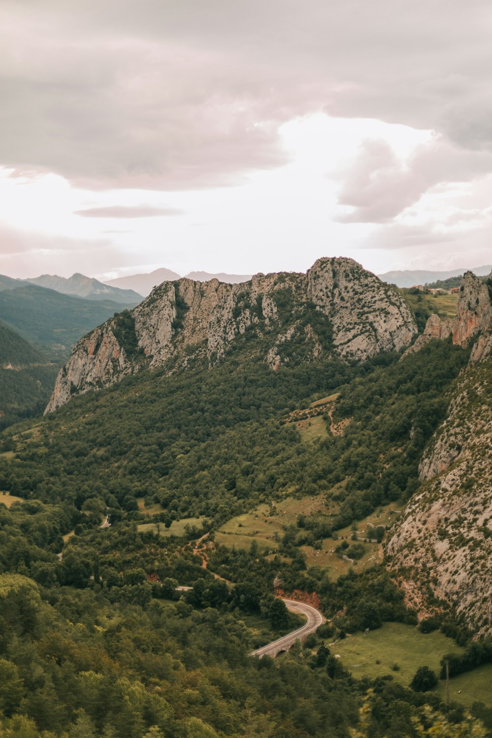 a scenic view of a valley with mountains in the background