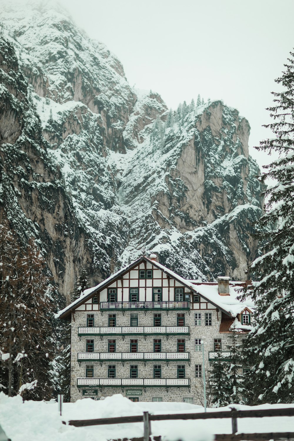 a house in the mountains covered in snow