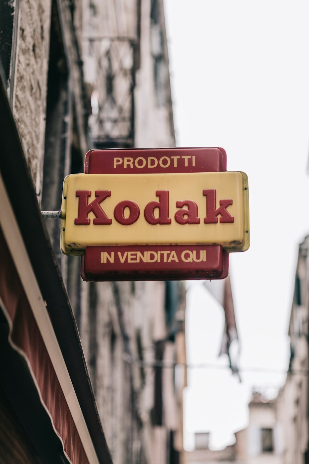 a kodak sign hanging from the side of a building