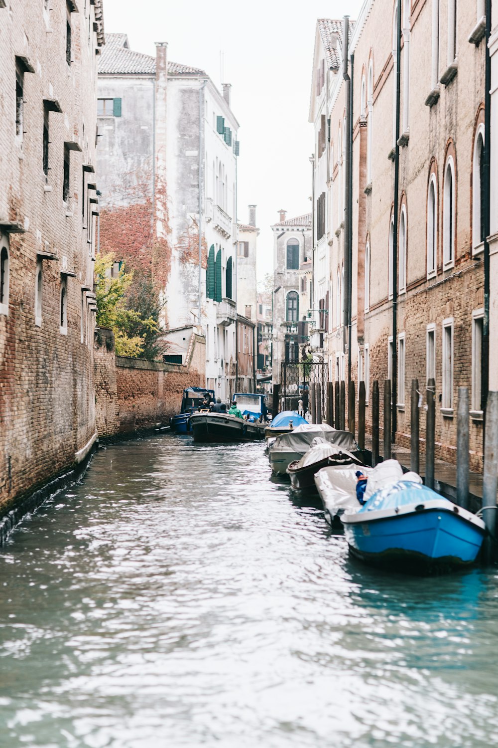 a narrow canal with several boats in it