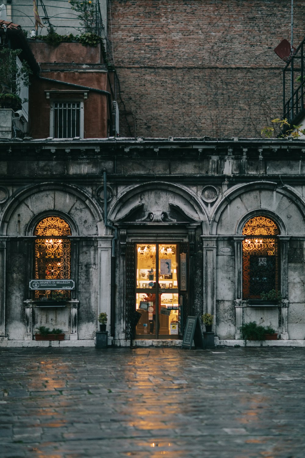 a store front with a clock on the front of it