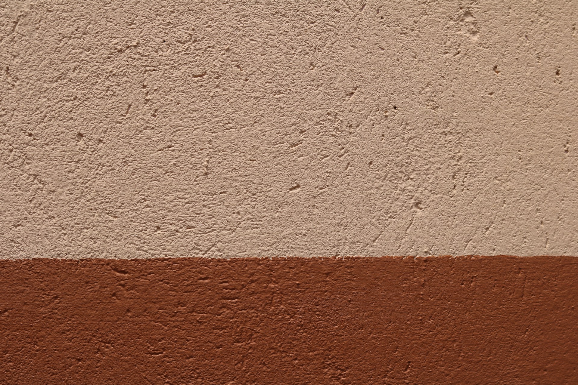 a brown and white wall with a red stripe