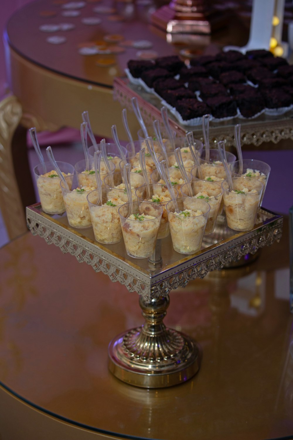 a table topped with a tray of cupcakes