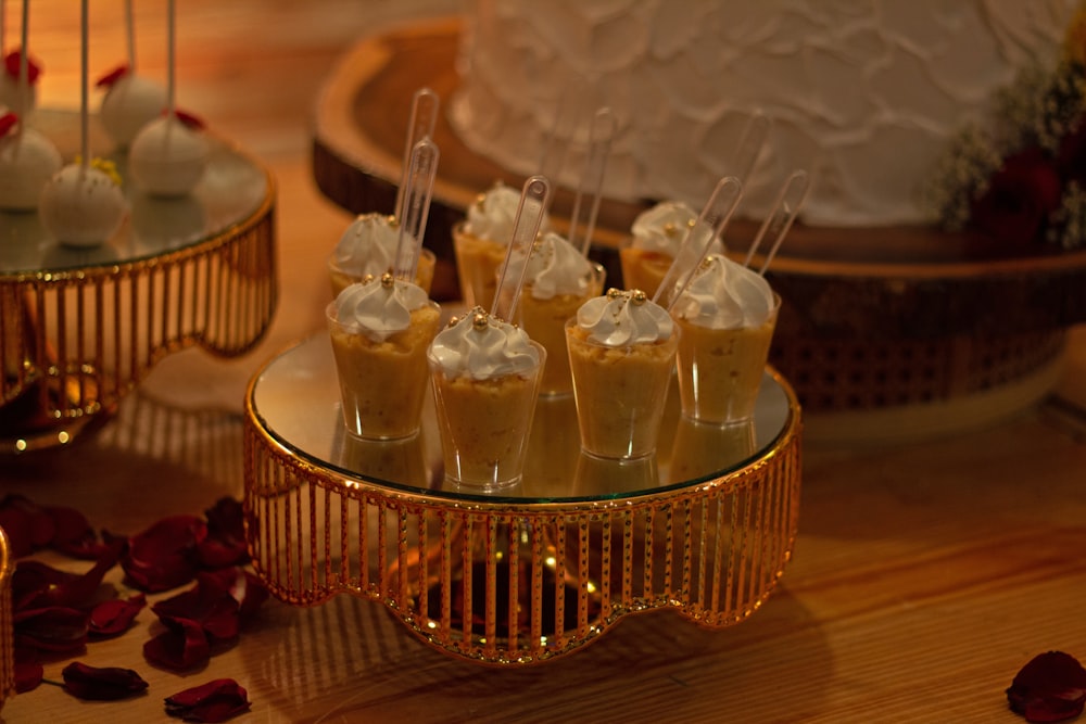 a table topped with cakes and desserts on top of a wooden table