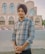 a man in a turban standing in front of a building