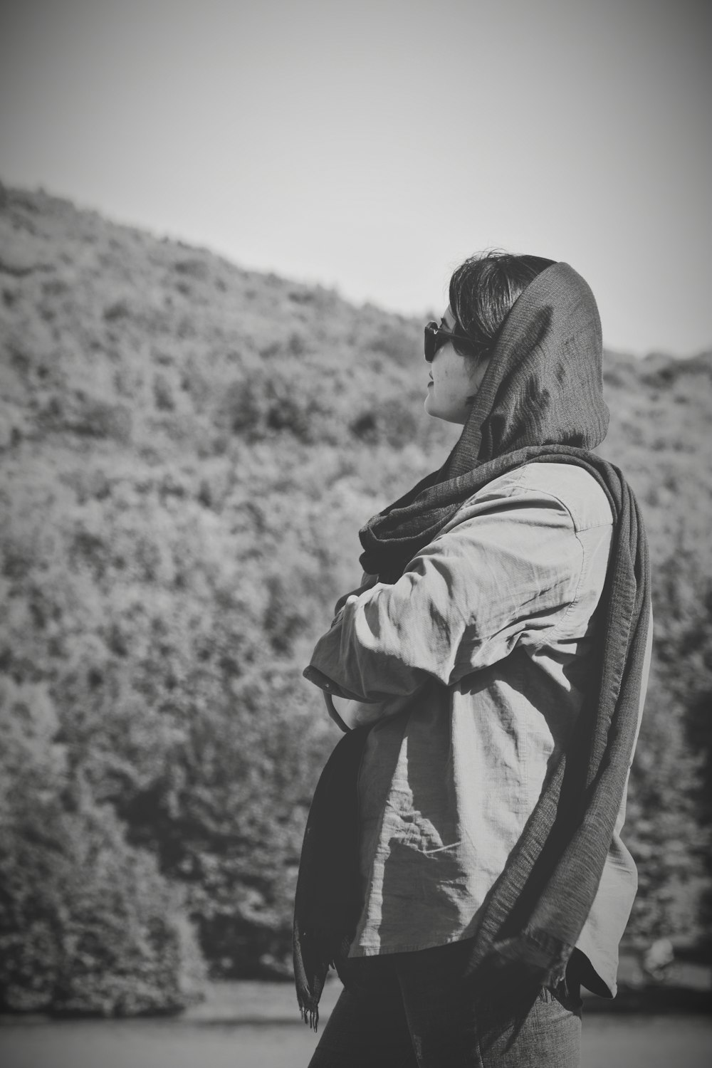 a woman standing in front of a mountain