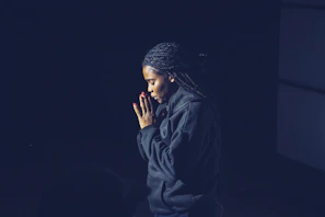 A candid moment of Monie praying before a race, reflecting faith and resilience.