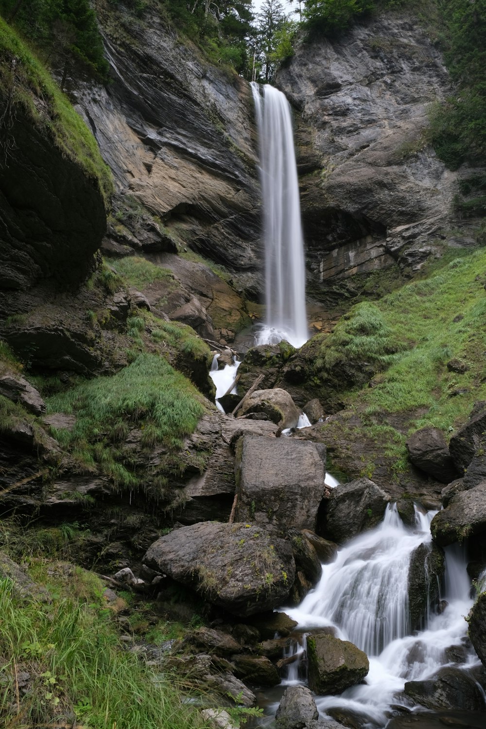 a small waterfall in the middle of a rocky area