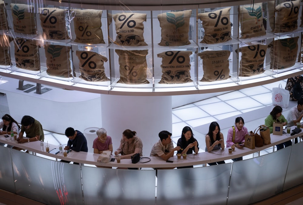 a group of people sitting at a counter in a store