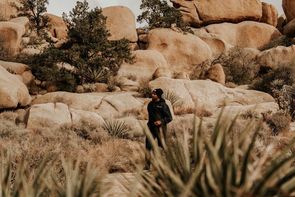 a man standing in the middle of a desert