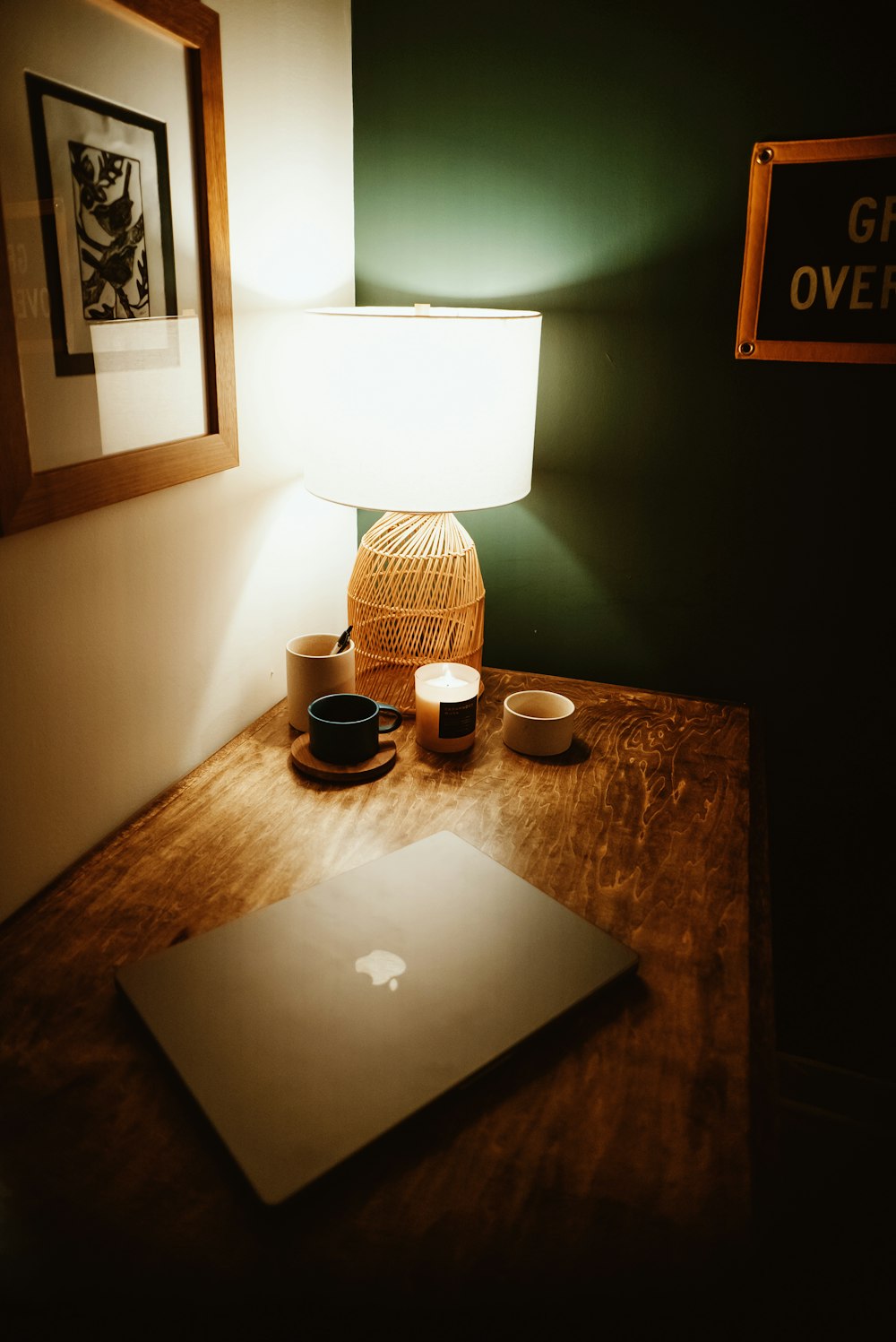 a laptop computer sitting on top of a wooden desk