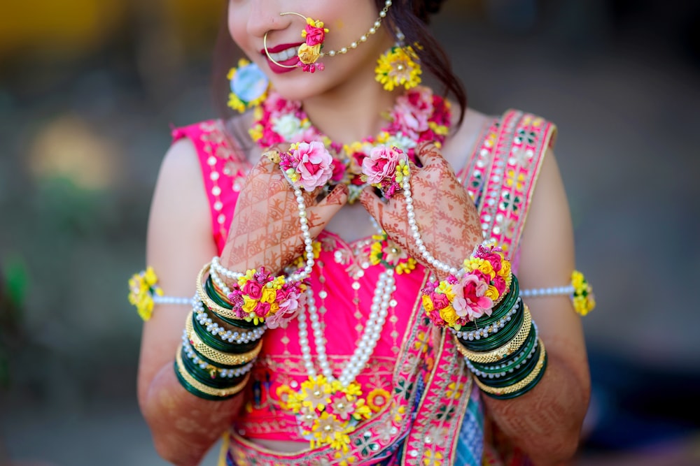a woman in a colorful outfit holding her hands together