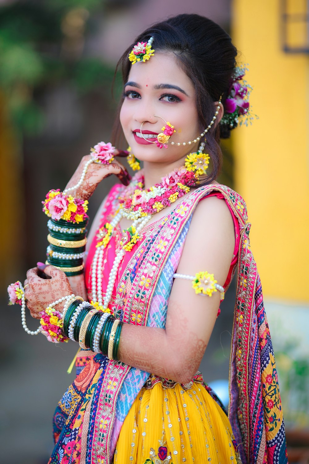 a woman dressed in a colorful outfit and jewelry