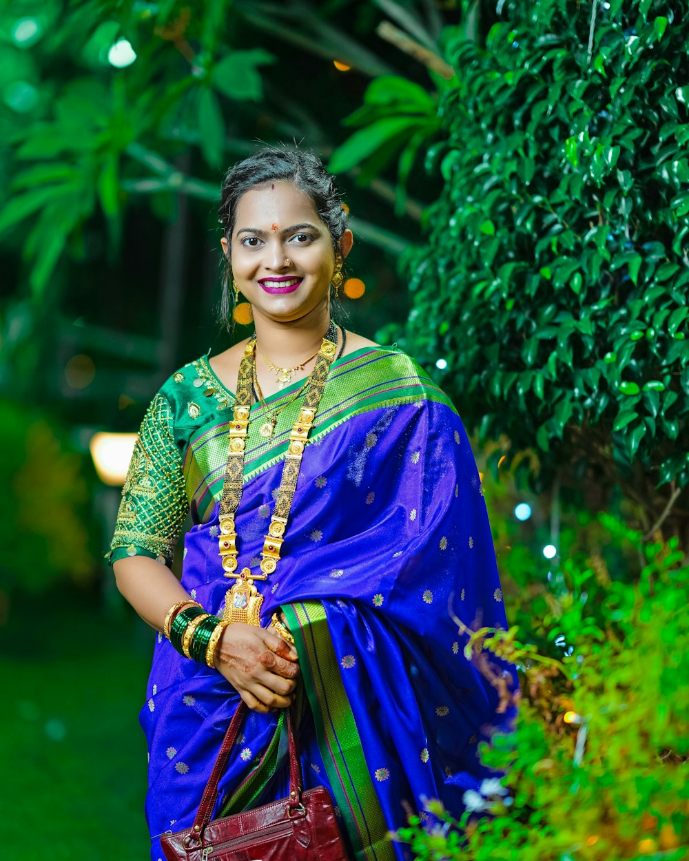 a woman in a blue and green sari