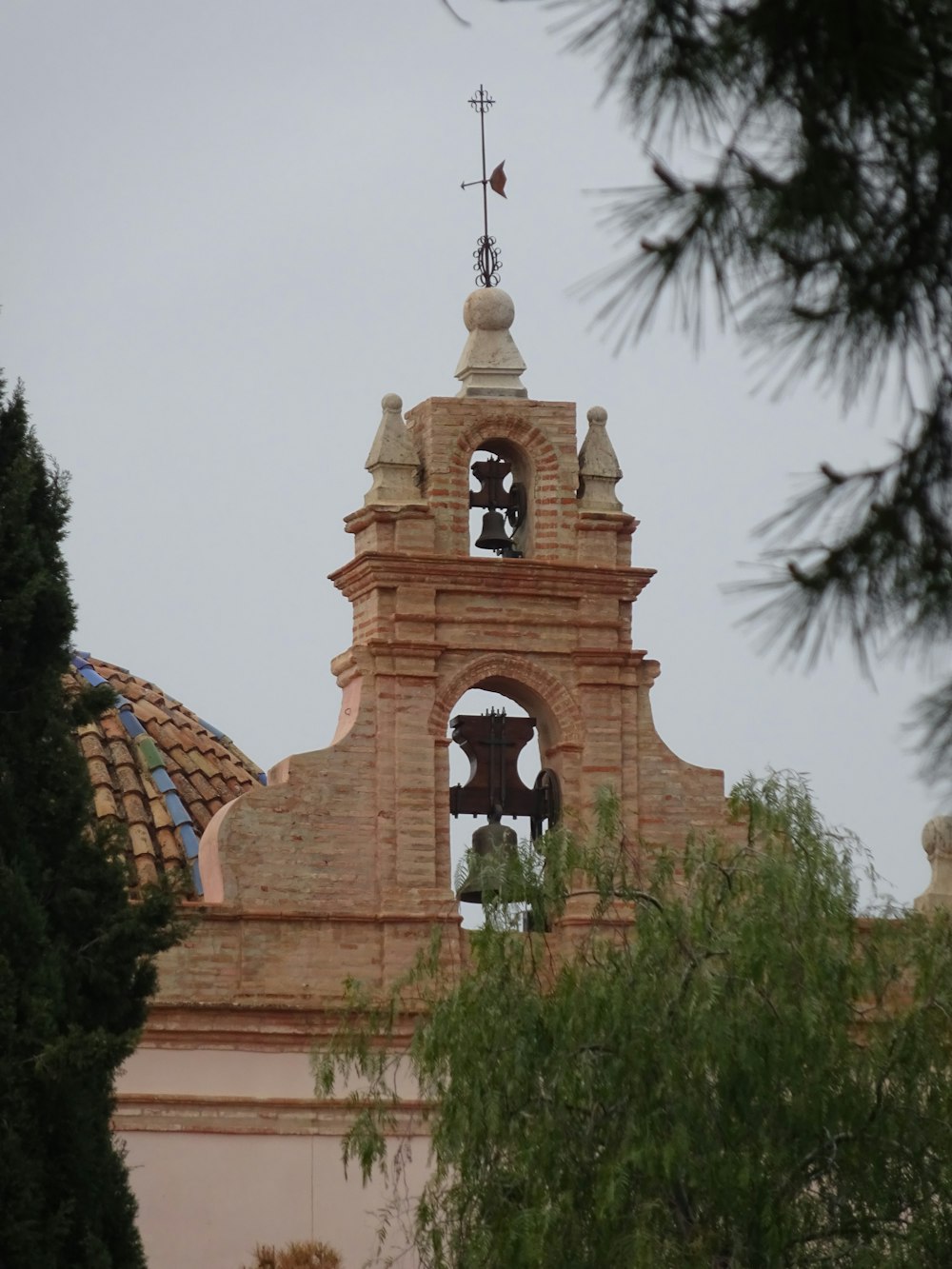 a clock tower with a bell on top of it